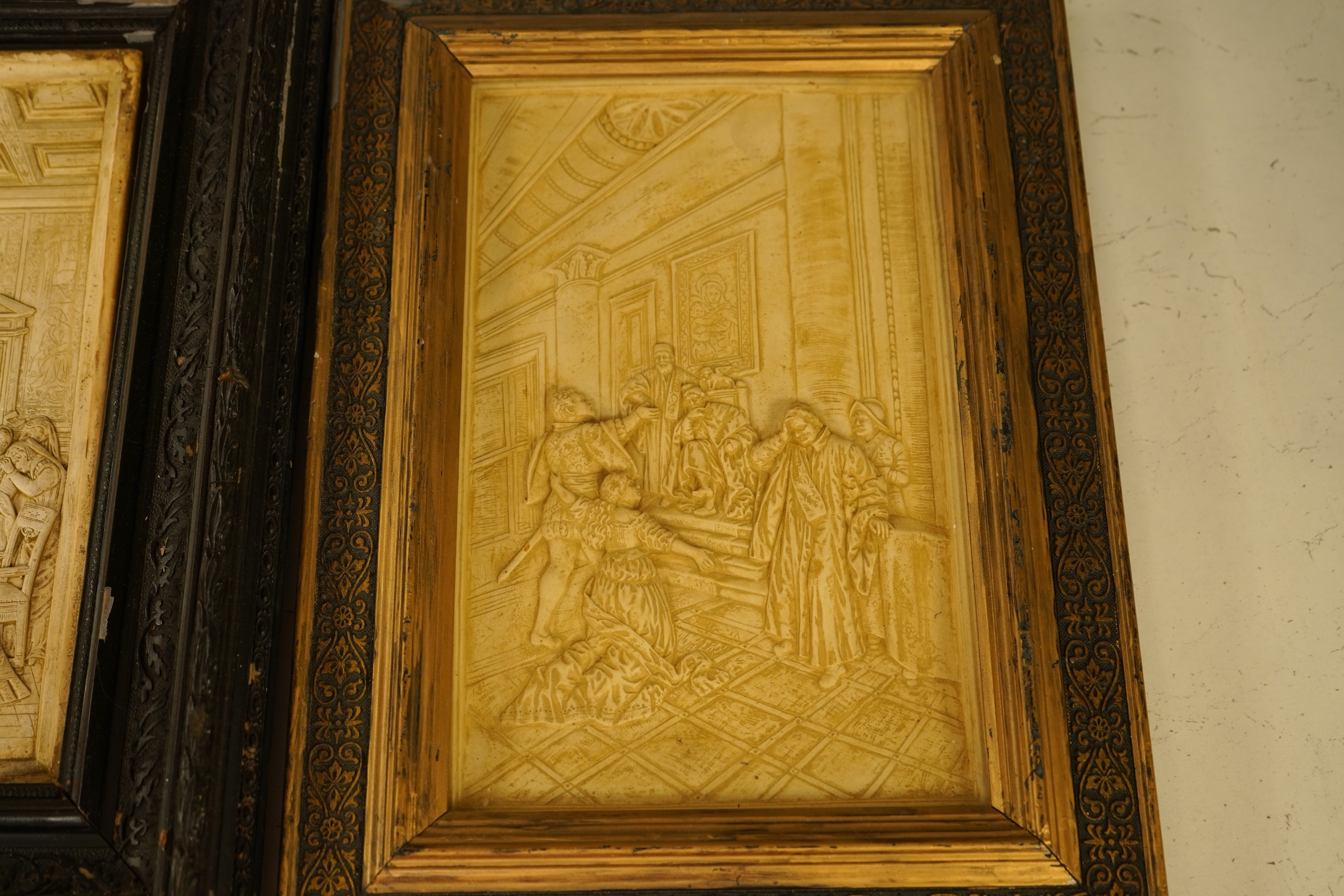 SVD., a pair of marquetry and penwork butterfly panels and a pair of relief moulded plaster panels depicting Tudor scenes, each framed, largest 41cm high